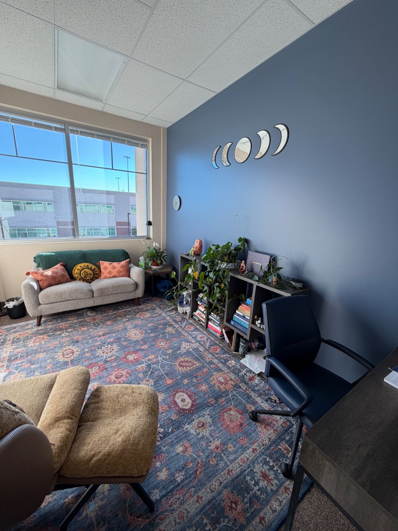 Counseling room with a sofa and blue accent wall at ABCounseling Group